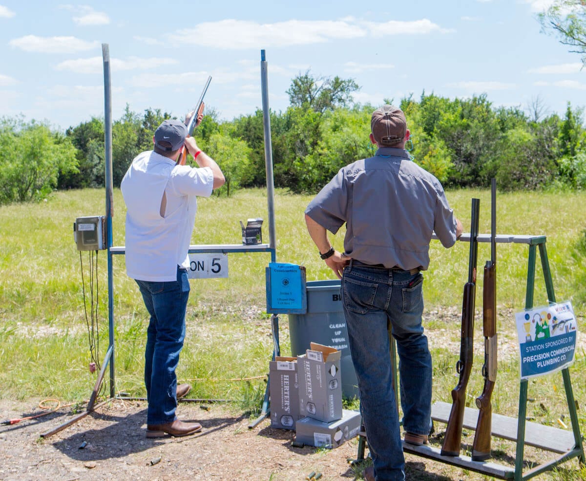 Two men shooting clay pigeons